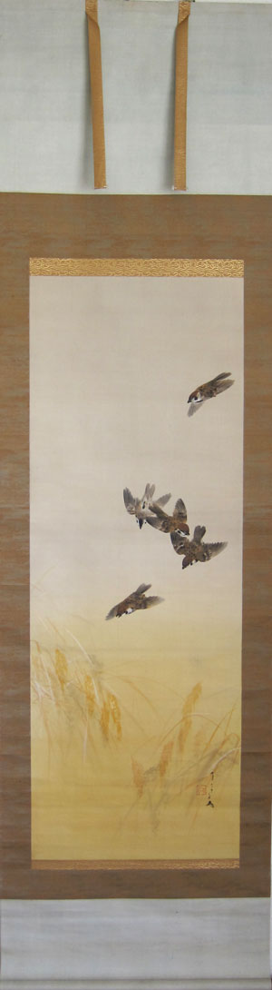 A group of sparrows in an autumn ricefield