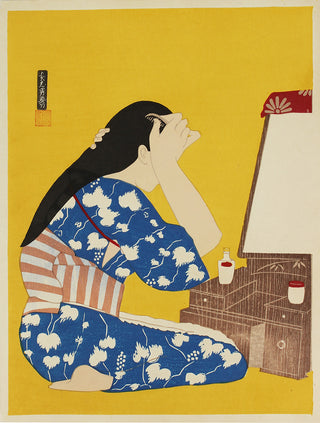 Woman seated in front of mirror